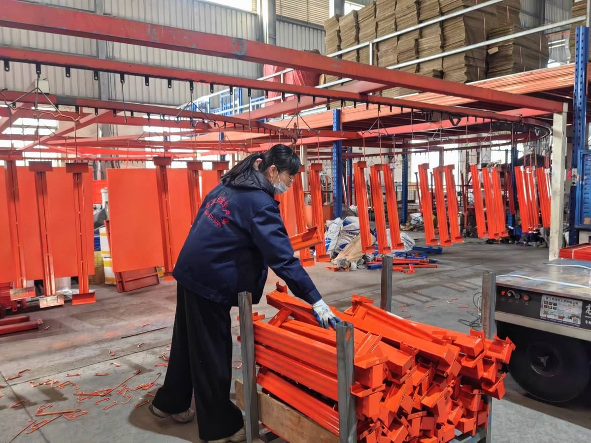 Two workers assembling a racking component