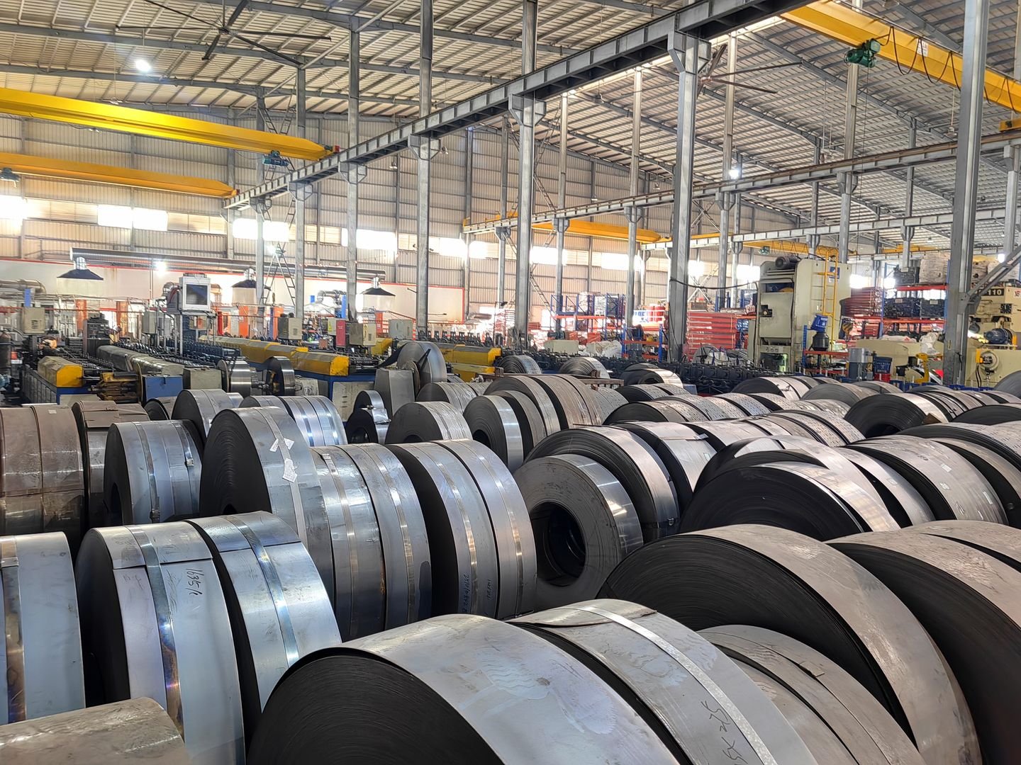 Slit steel coils stored indoors under an overhead crane